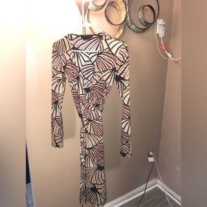 Low cut wrap dress. Fits snug. You can tie it in the front/side/back